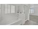 A bathroom with tub, shower, and a window with white shutters at 4909 Cherokee Run Ct, Las Vegas, NV 89131