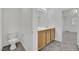 Bathroom with double sink vanity, gray tile floor, toilet, and access to walk in closet at 4909 Cherokee Run Ct, Las Vegas, NV 89131