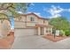 Two-story home with a well-maintained front yard, two-car garage, and a red tile roof at 4909 Cherokee Run Ct, Las Vegas, NV 89131