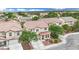 Beautiful two-story home with a red tile roof, lush landscaping, a driveway, and a two-car garage at 4909 Cherokee Run Ct, Las Vegas, NV 89131