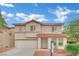 Charming two-story home with a stucco exterior, tile roof, and well-maintained landscaping at 4909 Cherokee Run Ct, Las Vegas, NV 89131