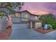 Charming two-story home with a stucco exterior, tile roof, and long driveway at 4909 Cherokee Run Ct, Las Vegas, NV 89131