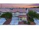 Charming two-story home with a red tile roof, inviting front entrance, and a well-manicured lawn at 4909 Cherokee Run Ct, Las Vegas, NV 89131