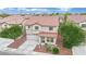 A lovely two-story home boasts a red tile roof, lush landscaping, a driveway, and a two-car garage at 4909 Cherokee Run Ct, Las Vegas, NV 89131