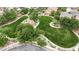 Inviting aerial view of green space with mature trees and landscaped pathways in a residential area at 4909 Cherokee Run Ct, Las Vegas, NV 89131