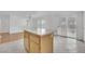 Kitchen island provides additional counter space, tile floors, and seating at 4909 Cherokee Run Ct, Las Vegas, NV 89131