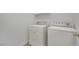Cozy laundry room featuring a stacked white washer and dryer against a clean white wall at 4909 Cherokee Run Ct, Las Vegas, NV 89131
