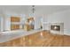 Open concept living room with stainless appliances, kitchen island, fireplace, and hardwood floors at 4909 Cherokee Run Ct, Las Vegas, NV 89131