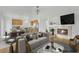 Open-concept living room and kitchen with hardwood floors and a fireplace at 4909 Cherokee Run Ct, Las Vegas, NV 89131