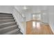 Bright living room features hardwood floors, staircase, natural light, and a white front door at 4909 Cherokee Run Ct, Las Vegas, NV 89131