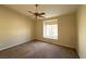 Neutral bedroom with a ceiling fan and a large window at 4941 Black Bear Rd # 202, Las Vegas, NV 89149