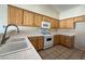 Functional kitchen with white appliances and tile countertops at 4941 Black Bear Rd # 202, Las Vegas, NV 89149