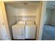 Convenient laundry closet featuring a white washer and dryer set with ample shelving at 4941 Black Bear Rd # 202, Las Vegas, NV 89149