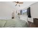 A bright bedroom with wood floors, a ceiling fan, and a view of the backyard at 504 Crony Ave, Henderson, NV 89011