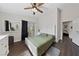 Well-lit bedroom with wood floors, ceiling fan, and direct access to the backyard at 504 Crony Ave, Henderson, NV 89011