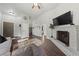 Spacious living room with a fireplace, wood floors, vaulted ceiling, and plenty of seating at 504 Crony Ave, Henderson, NV 89011