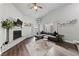 Inviting living room with a painted brick fireplace, wood floors, and vaulted ceiling at 504 Crony Ave, Henderson, NV 89011