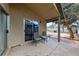 Covered patio with outdoor seating, adjacent to a landscaped backyard at 504 Crony Ave, Henderson, NV 89011