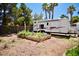 Backyard featuring a garden bed and space for recreational vehicles, surrounded by lush greenery at 5412 Rainbows End Dr, Las Vegas, NV 89149