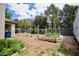 A spacious backyard featuring a raised garden bed, cinder block fencing, and mature trees, with room to customize at 5412 Rainbows End Dr, Las Vegas, NV 89149