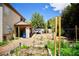 Backyard featuring a covered patio, clothes line, and vegetable garden, perfect for outdoor entertaining at 5412 Rainbows End Dr, Las Vegas, NV 89149