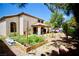 An expansive backyard features a garden bed and covered patio perfect for outdoor relaxation at 5412 Rainbows End Dr, Las Vegas, NV 89149