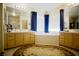 Bright bathroom featuring dual sinks, tub, and shower at 5412 Rainbows End Dr, Las Vegas, NV 89149