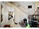 Open entryway featuring neutral tile flooring, a staircase, and a view into the living area at 5412 Rainbows End Dr, Las Vegas, NV 89149