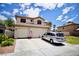 Inviting two-story home with a well-maintained lawn, three car garage and beautiful blue sky at 5412 Rainbows End Dr, Las Vegas, NV 89149