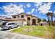 Lovely two-story house with a three-car garage, well-kept lawn and landscaping, sunny sky at 5412 Rainbows End Dr, Las Vegas, NV 89149