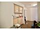 Hallway featuring a built in wood cabinet and tan carpet flooring at 5412 Rainbows End Dr, Las Vegas, NV 89149