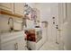 A functional laundry room with sink, washer, dryer, and ample storage space in neutral tones at 5412 Rainbows End Dr, Las Vegas, NV 89149