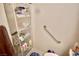 Shower featuring a hand rail, built in shelving and tile walls at 5412 Rainbows End Dr, Las Vegas, NV 89149