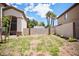 Nice yard with mature palm trees and a gate to the side yard offering privacy and shade at 5412 Rainbows End Dr, Las Vegas, NV 89149