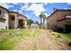 View of the spacious side yard featuring mature trees and lush green grass; perfect for outdoor activities at 5412 Rainbows End Dr, Las Vegas, NV 89149