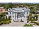 Beautiful aerial view of a grand two-story home featuring a rooftop deck and manicured landscaping at 56 Quail Run Rd, Henderson, NV 89014