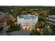 A luxury home with flat roof design, surrounded by lush greenery and mature trees in a residential neighborhood at 56 Quail Run Rd, Henderson, NV 89014