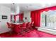 Home bar area with red upholstered bar, bar stools, and large mirror at 56 Quail Run Rd, Henderson, NV 89014