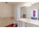Bathroom with marble-style bathtub, toilet, and vanity with a mirror at 56 Quail Run Rd, Henderson, NV 89014