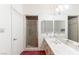 Bright bathroom with marble countertops, shower, and white cabinets at 56 Quail Run Rd, Henderson, NV 89014