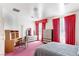 Bright bedroom features pink carpet, red curtains, and a matching desk and dresser set at 56 Quail Run Rd, Henderson, NV 89014