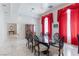 Spacious dining room with large table, marble floors, and ornate window coverings at 56 Quail Run Rd, Henderson, NV 89014