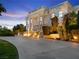 Elegant two-story home featuring grand columns, dual staircases, and manicured landscaping at 56 Quail Run Rd, Henderson, NV 89014
