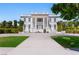 Two-story home featuring grand columns, dual staircases, and manicured landscaping at 56 Quail Run Rd, Henderson, NV 89014
