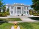 Two-story home featuring grand columns, dual staircases, and lush landscaping at 56 Quail Run Rd, Henderson, NV 89014