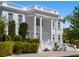 Elegant two-story home featuring grand columns, dual staircases, and manicured landscaping at 56 Quail Run Rd, Henderson, NV 89014