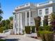 Two-story home featuring grand columns, dual staircases, and manicured landscaping at 56 Quail Run Rd, Henderson, NV 89014