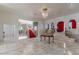Open foyer featuring marble floors, staircase, and decorative archways with red curtains at 56 Quail Run Rd, Henderson, NV 89014