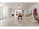 Bright foyer with marble floors, crystal chandelier, and staircase with red carpet at 56 Quail Run Rd, Henderson, NV 89014