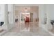 Grand foyer with marble flooring, columns, and a staircase with red carpet runner at 56 Quail Run Rd, Henderson, NV 89014